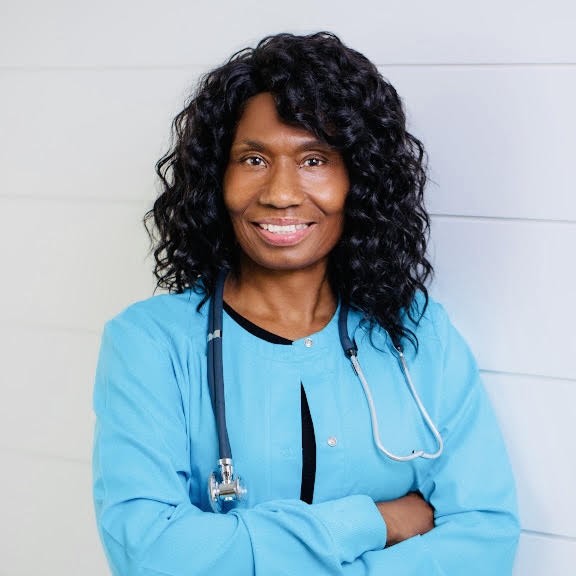 Jacquelyne Underwood, RN, MSN — Founder of Nurse Moves, in scrubs with a stethoscope